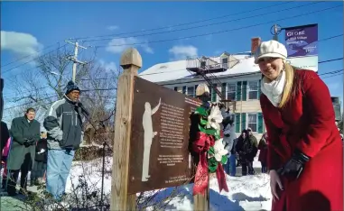  ?? Photos by Russ Olivo/The Call ?? Margaux Morisseau, director of community engagement for NeighborWo­rks Blackstone River Valley, lays a wreath at the memorial plaque at the King Memorial at South Main and Mason streets on Monday. To the left are St. James Baptist Church Deacon and MLK...