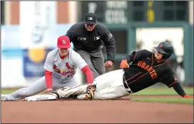  ?? THEARON W. HENDERSON/GETTY IMAGES ?? The Giants' Wilmer Flores, right, is tagged out at second base by Cardinals infielder Tommy Edman on Thursday in San Francisco.