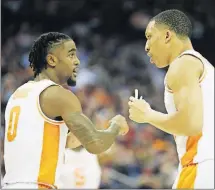  ?? [JOSHUA A. BICKEL/DISPATCH] ?? Jordan Bone, left, and Grant Williams of Tennessee talk on the court during the first-round game Friday at Nationwide Arena. Tennessee vs. Iowa When: 12:10 p.m. today TV: CBS (Ch. 10)