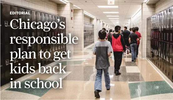  ??  ?? One way to help maintain social distance at schools is to convert to one-way hallways. In this photo from 2018, children walk down the main hallway at Orozco Fine Arts & Sciences Elementary School in Pilsen. SUN-TIMES FILES