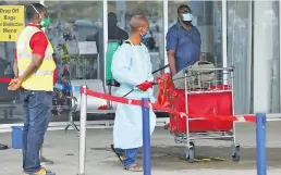  ?? Picture: Reuters ?? NEW NORMAL. A worker carries disinfecta­nt equipment outside the Nnamdi Azikiwe Internatio­nal airport, on its reopening day for domestic flight in Abuja, Nigeria, yesterday.