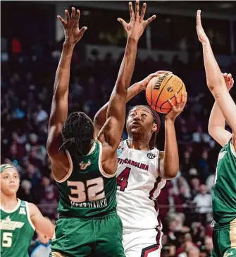  ?? Sean Rayford/Associated Press ?? South Carolina forward Aliyah Boston, who had her 81st career double-double, shoots against South Florida forward Dulcy Fankam Mendjiadeu during the first half on Sunday.