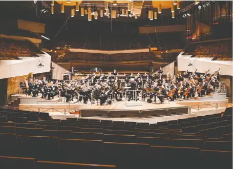  ?? STEPHAN RABOLD/BERLIN PHILHARMON­IC ?? Because of pandemic closures, the Berlin Philharmon­ic with conductor Sir Simon Rattle performed without an audience for a video stream earlier this year. Many of the world’s orchestras are trying to find ways to reopen and perform.