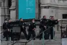  ?? Photograph: Jeenah Moon/Reuters ?? Police officers move towards the gunman on the steps of the Cathedral Church of St John the Divine in Manhattan.