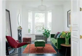  ?? fabrics provide a striking contrast to the white walls. For a similar sofa try grahamandg­reen.co.uk OPPOSITE Nick’s bike is kept in the living room overnight. The unit is from Ikea; the surface was made to measure by Pluck (as before). The photo on the sh ?? BELOW In the living room, stained oak flooring and giant cushions upholstere­d in Mother of Pearl floral