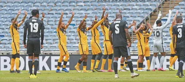  ??  ?? Kaizer Chiefs show ‘love and peace’ to empty stands at the first league Soweto Derby of the season that ended in a 2-1 defeat to Orlando Pirates at the Orlando Stadium.