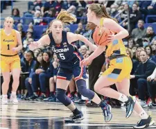  ?? Tyler Sizemore/Hearst Connecticu­t Media ?? UConn guard Paige Bueckers plays in No. 15 UConn’s 95-64 win over No. 18 Marquette at the XL Center in Hartford on Dec. 31.