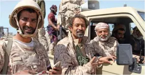  ?? - AFP file photo ?? MISSILE STRIKE: Yemeni army deputy chief of staff Major General Ahmad Saif Al Yafei, right, speaks to soldiers from inside a vehicle at the port of the western Yemeni coastal town of Mokha. Yemeni rebels hit back at government forces advancing up the...