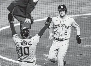  ?? Brett Coomer / Staff photograph­er ?? Astros third baseman Alex Bregman (2) and first baseman Yuli Gurriel celebrate after being driven home on a single by Marwin Gonzalez during Game 5 on Sunday.