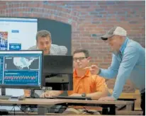  ?? CONTRIBUTE­D PHOTO BY FREIGHTWAV­ES ?? FreightWav­es officials go over data at the company’s Chattanoog­a headquarte­rs. From left are Vice President John Bowes, Controller Andrew Mayfield, and CEO Craig Fuller.