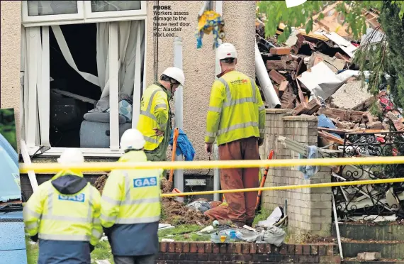  ?? ?? PROBE Workers assess damage to the house next door. Pic: Alasdair MacLeod