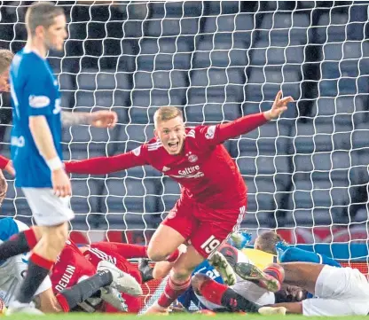  ?? Picture: SNS. ?? Lewis Ferguson turns away to celebrate after heading in the goal that settled the Hampden meeting with Rangers in Aberdeen’s favour.