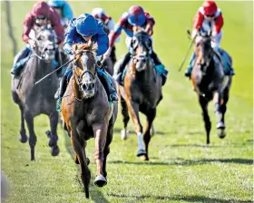  ??  ?? Out on his own: Masar storms clear of the field at Newmarket yesterday