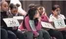  ??  ?? Young competitor­s wait their chance at the microphone Feb. 11 during the Greater Memphis Spelling Bee at the Al Chymia Shrine Temple.