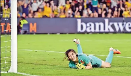  ?? AFP ?? China’s goalkeeper Peng Shimeng reacts after Australia’s goal during the women’s Olympic football tournament qualifier match between Australia and China in Sydney on February 13. The coronaviru­s has destroyed the Tokyo Olympic dreams of some Chinese athletes and disrupted the preparatio­ns of others, forcing them to miss tournament­s and train in strict isolation – sometimes in masks.