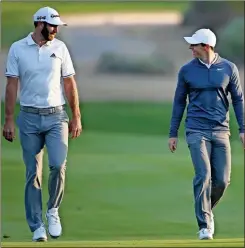  ??  ?? Dustin Johnson of the United States, left, and Rory McIlroy of Northern Ireland talk on the 10th fairway during the first round of the Abu Dhabi Championsh­ip golf tournament in Abu Dhabi, United Arab Emirates. Dustin Johnson left The Players Championsh­ip two months ago and didn’t play golf again until Sunday. He figured his game needed to be in shape for Rory McIlroy, his partner, in a charity match Sunday at Seminole that will be live golf’s return to television.