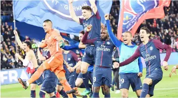  ?? — AFP photo ?? Paris Saint-Germain’s players celebrate after winning the French L1 match against Monaco at the Parc des Princes stadium in Paris.