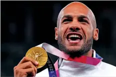  ?? FRANCISCO SECO ASSOCIATED PRESS FILE PHOTO ?? Lamont Marcell Jacobs of Italy poses in 2021 with his gold medal following the men’s 100-meter final at the 2020 Summer Olympics in Tokyo. Track and field is set to become the first sport to introduce prize money at the Olympics.