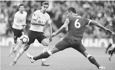  ??  ?? Tottenham Hotspur’s English midfielder Harry Winks (left) vies with Liverpool’s Croatian defender Dejan Lovren during the English Premier League football match at Wembley Stadium in London. — AFP photo