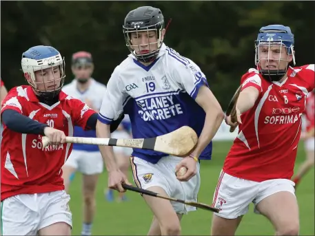  ??  ?? Ronan Byrne of Ballyhogue under heavy pressure from Robbie Rochford and Adam Waters of Moguegeen Gaels.