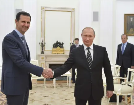  ?? (Alexei Druzhinin/Reuters) ?? RUSSIAN PRESIDENT Vladimir Putin (right) shakes hands with Syrian President Bashar Assad during a meeting at the Kremlin in Moscow in 2015.