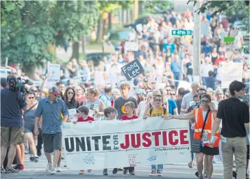  ??  ?? FIGHT THE POWER: Protesters march through the neighbourh­ood where Justine Damond was shot and killed by police.
