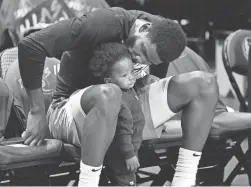  ?? ROB SCHUMACHER/THE REPUBLIC ?? Suns center Deandre Ayton kisses Deandre Ayton Jr. before Game 4 of the playoff series with the Mavericks on May 8.