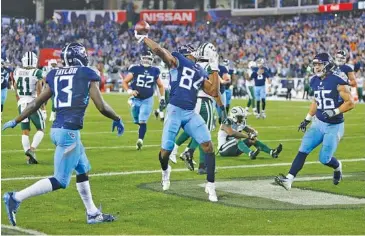  ?? AP PHOTO/JAMES KENNEY ?? Tennessee Titans wide receiver Corey Davis (84) celebrates after scoring the game-winning touchdown on an 11-yard pass from Marcus Mariota in the fourth quarter of Sunday’s game against the New York Jets in Nashville. The Titans won 26-22 to improve to 6-6 and keep their hopes of a wild-card playoff spot alive.