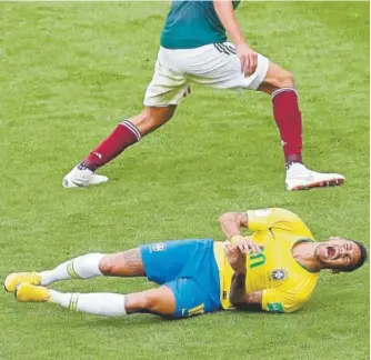  ?? Sergei Grits, The Associated Press ?? Neymar, bottom, has been called out for his theatrics that some say distracted from Brazil’s 2-0 victory over Mexico on Monday.