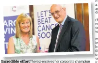  ??  ?? Incredible effort Therese receives her corporate champion of the year award from Cancer Research UK chairman Sir Leszek Borysiewic­z