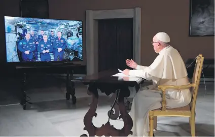  ?? Picture: Reuters ?? REACHING OUT. Pope Francis talks to crew members of the Internatio­nal Space Station, ISS Expedition 53, during an audio-video connection at the Vatican yesterday.