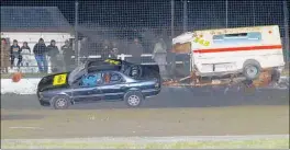  ??  ?? Roger Dettling slams into the wall with his car and caravan during the caravan race at Stratford Speedway on Saturday night.