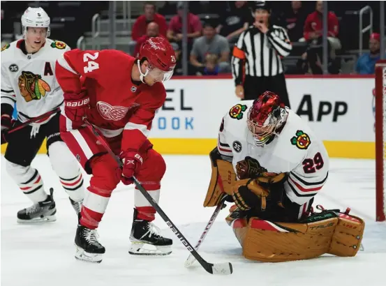  ?? PAUL SANCYA/AP ?? Hawks goalie Marc-Andre Fleury stops a point-blank shot by Red Wings center Pius Suter in the second period of a preseason game Monday in Detroit.