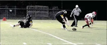  ?? MARK HUMPHREY ENTERPRISE-LEADER ?? Prairie Grove junior Graham Guenther scoops up a blocked punt, which he returned 8 yards for a touchdown during Friday’s 63-0 win by the Tigers over conference newcomer Green Forest.