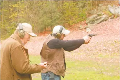  ?? Hearst Connecticu­t Meida file photo ?? Dominic Cassano, of New Fairfield, practices with his Smith & Wesson revolver while Walt Vaillancou­rt keeps time at the shooting range at Wooster Mountain State Park in Danbury earlier this year.