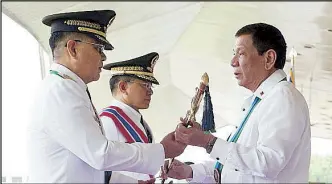  ??  ?? President Duterte receives the Command Saber from Gen. Eduardo Año before handing it over to newly installed AFP chief Lt. Gen. Rey Leonardo Guerrero at Camp Aguinaldo yesterday.