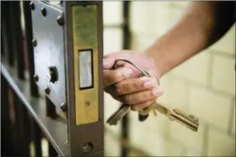  ?? AP PHOTO/MATT ROURKE ?? In this Tuesday, Oct. 23, 2018 photo, a guard opens a gate at the deactivate­d House of Correction in Philadelph­ia.