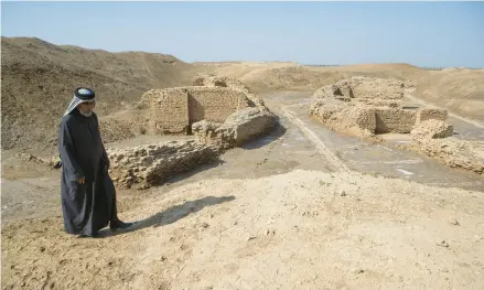  ?? NABIL AL-JOURANI/AP ?? One of the world’s oldest bridges, believed to be 4,000 years old, pops into view near the ancient city-state of Lagash, near Nasiriyah, Iraq.
