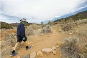  ?? LUIS SÁNCHEZ SATURNO/THE NEW MEXICAN ?? Ron Newman of Santa Fe walks on a trail Monday at the Santa Fe Canyon Preserve. State officials have crafted their first Forest Action Plan in a decade.