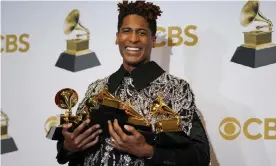  ?? Photograph: John Locher/Invision/AP ?? Jon Batiste poses with his haul of awards.