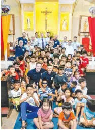 ?? ?? TEAM ULIS with the children from BASECO. With them is Count Hubert d'aboville (with necktie), founder and prersident of Together-ensemble Foundation (Together Ensemble-team ULIS photo)