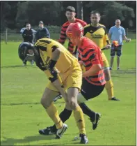  ??  ?? Just about rememberin­g to take the ball with him is Inveraray player/manager, Gary MacPherson, who is being closely marked by Oban Camanachd’s Garry Lord. The Oban side won the Marine
Harvest Premier Division basement battle 2- 0