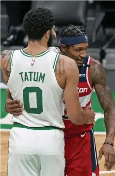  ?? AP FIle ?? KEEP YOUR DISTANCE: Celtics star Jayson Tatum hugs Wizards star Bradley Beal on Friday. With Tatum testing positive for the coronaviru­s, the league is looking to avoid on court interactio­n before and after games to prevent spread.