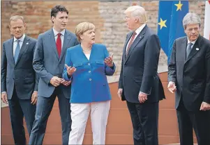  ?? AP PHOTO ?? G7 leaders (from left) EU President Jean-Claude Junker, Canadian Prime Minister Justin Trudeau, German Chancellor Angela Merkel, President Donald Trump, and Italian Prime Minister Paolo Gentiloni, pose for a family photo at the Ancient Greek Theater of...