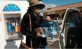  ??  ?? A woman fills up drinking water containers from a kiosk in Orosi. Photograph: Max Whittaker/The Guardian