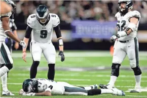  ?? GETTY IMAGES ?? Philadelph­ia’s Alshon Jeffery is consoled by Nick Foles after Jeffery allowed a pass to go through his hands that led to a late intercepti­on.