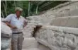  ??  ?? Archeologi­st Richard Hansen shows off a stucco frieze that he uncovered at El Mirador.