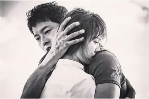  ??  ?? Song embracing Joong-Ki in a scene from the Descendant­s Of The Sun.