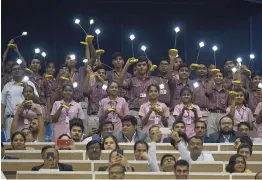  ?? — AFP ?? Schoolchil­dren light solar lamps during an event in New Delhi on Tuesday.