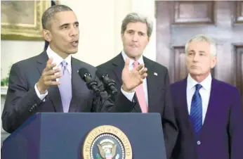  ?? (AFP FOTO) ?? MILITARY ENGAGEMENT. President Barack Obama (left) delivers remarks on legislatio­n he sent to Congress in Washington to authorize the use of military force against the Islamic State.